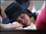  A woman cries over the coffin of  her boyfriend at a gymnasium where bodies were brought for identification in Santa Maria city, Rio Grande do Sul state, Brazil, Sunday.