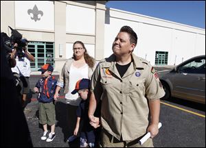 In this 2012 photo, Jennifer Tyrrell, right, arrives for a meeting at the Boys Scouts of America national offices in Irving, Texas, with her son Jude Burns, 5, second from right, partner Alicia Burns, and son Cruz Burns, 7, left. The Ohio woman was ousted as a den mother because she is a lesbian. 