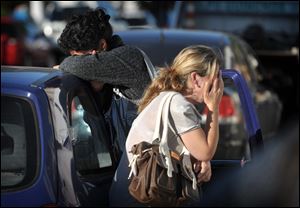 Relatives wait for news near the Kiss nightclub in Santa Maria, Brazil. An official said firefighters had trouble getting in because the entrance was blocked by bodies.