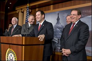 A burst of laughter erupts during a news conference where a bipartisan group of leading senators announce that they have reached agreement on the principles of sweeping legislation to rewrite the nation's immigration laws. From left are Sen. John McCain, R-Ariz., Sen. Charles Schumer, D-N.Y., Sen. Marco Rubio, R-Fla., Sen. Dick Durbin, D-Ill., and Sen. Robert Menendez, D-N.J. 