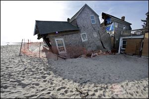 A beach front home that was severely damaged by Superstorm Sandy rests in the sand in Bay Head, N.J.