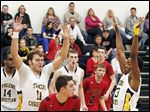  Toledo Christian defenders surround Cardinal Stritch's Austin Adams during the second half. TC sank 13 of 14 free throws in the fourth quarter to prevail, winning its 13th straight game.