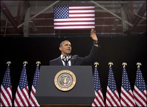 President Barack Obama waves as he arrives to speak about immigration at Del Sol High School in Las Vegas.