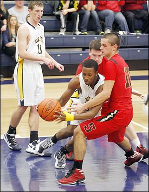 Toledo Christian's Melvin Thomas, center, is guarded by Cardinal Stritch's Joey Cousino, who scored 11 of his 16 points during a 16-5 run in the second quarter.