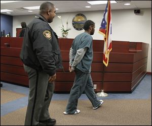 Titus Crittendon heads back to juvenile detention following a hearing in Lucas County juvenile court on Nov. 26.
