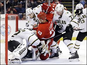 The Red Wings' Johan Franzen is tied up between the Stars' Stephane Robidas, Michael Ryder, and goalie Kari Lehtonen during the second period.
