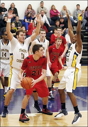 Toledo Christian defenders surround Cardinal Stritch's Austin Adams during the second half. TC sank 13 of 14 free throws in the fourth quarter to prevail, winning its 13th straight game.