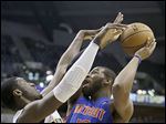  The Pistons' Greg Monroe puts up a shot against the Pacers' Roy Hibbert during the first half of Wednesday's game. Monroe finished with 18.