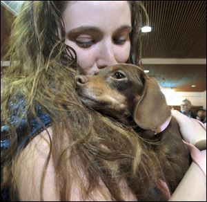 Mandi Smith, of Fort Campbell, Ky., is reunited with her dog, Pooka, today at the Albuquerque International Sunport Airport in Albuquerque, N.M.
