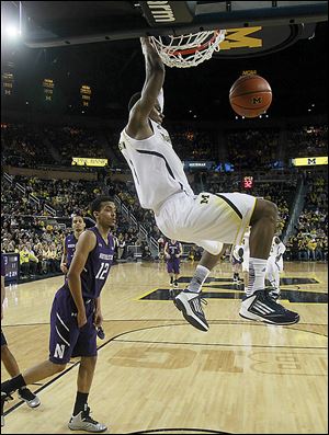 Michigan forward Glenn Robinson III dunks against Northwestern on Wednesday. Robinson scored 13 points on 6-of-7 shooting.