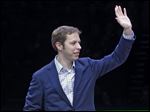 NASCAR driver Brad Keselowski waves to the crowd after receiving a plaque signed by the Detroit Pistons in honor of his 2012 NASCAR Sprint Cup Series championship.