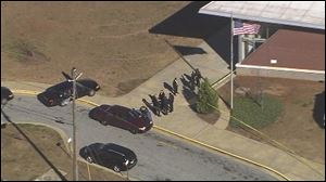 Authorities investigate the scene of a school shooting in Atlanta.
