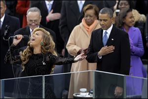 President Barack Obama stands with his hand over his heart as Beyonce performed the national anthem at the ceremonial swearing-in at the U.S. Capitol during the 57th Presidential Inauguration in Washington.