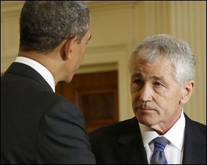 President Barack Obama shakes hands with Defense Secretary-nominee, former Nebraska Sen. Chuck Hagel, in the East Room of the White House in Washington.