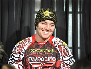 Snomobiler Caleb Moore smiles while attending a news conference at the Winter X Games in Aspen, Colo.