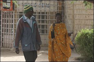 A man and a woman walk together today, which would not be allowed under the rule of Islamic militants who ruled the city until French troops took control, in Timbuktu, Mali.