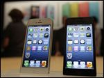  The new Apple iPhone 5 is displayed Wednesday Sept. 12, 2012 following the introduction of new products in San Francisco.  The iPhone 5 is a blend of beauty, utility and versatility. (AP Photo/Eric Risberg)