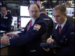  In this Friday, Jan. 25, 2013, photo, Specialist Douglas Johnson, left, and trader Timothy Nick work on the floor of the New York Stock Exchange. Some rare good economic news from Europe pushed world stock markets higher on Friday Feb. 1, 2013 as investors awaited a key U.S. employment report that is expected to show steady, if unremarkable, job growth.  (AP Photo/Richard Drew)