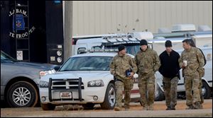 Law enforcement officials continue to work the scene of the hostage crisis in Midland City, Ala., Friday, Feb. 1, 2013. 