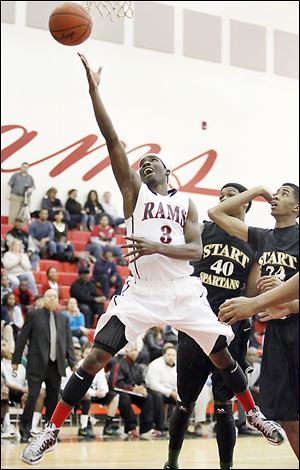 Rogers senior Tony Kynard, who finished with 24 points, goes to the net against  Start's Michael Mitchell.
