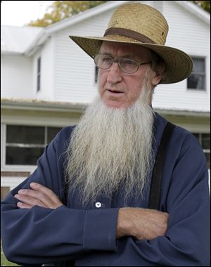 Sam Mullet Sr. stands in the front yard of his home in Bergholz, Ohio.