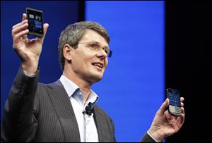Thorsten Heins, CEO of BlackBerry, holds the company's new smartphones -- touchscreen Z10, left, and, for BlackBerry keyboard loyalists, the Q10.