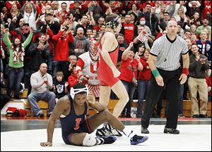 Ohio State fans celebrate with Logan Stieber after he pins Illinois' Daryl Thomas during their 133-pound match at Oak Harbor High School. Stieber had missed the last five duals with an injury.
