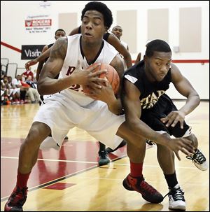 Rogers' Tribune Dailey, Jr., keeps a rebound away from Start's David Cox in the Rams' victory. Dailey scored 12 points.
