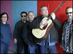  Members of the band Los Lobos, from left, Louie Perez, Cesar Rosas, Conrad Lozano, David Hidalgo holding a guitar, and Steve Berlin posing for a photograph, in Los Angeles.