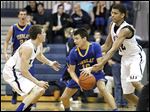  Findlay's Grant Niswander, center, is pressured by St. John's Jesuit's Austin Gardner, left, and Marc Loving during Friday’s game at St. John's. Gardner had 15 points while Loving added 12.