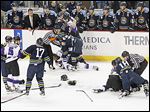  Referees attempt to break up a multiplayer fight that broke out during the second period on Saturday.