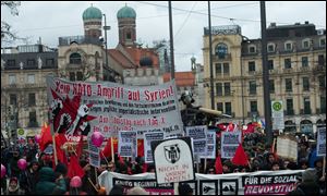 Demonstrators protest with banners and signs during a rally against the 49th Munich Security Conference today in Munich, Germany. The poster in center reads : No NATO attack on Syria.