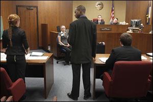 Central Catholic's Brandon Loveless, standing, objects to a question from Edon attorney Becky Fisk, left, during the Ohio Center for Law-Related Education's 2013 Ohio High School Mock Trial Competition at Toledo Municipal Court.