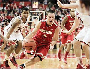 Ohio State's Aaron Craft, center, drives between Nebraska's Dylan Talley, left, and Andre Almeida, right, in the second half. Craft finished the contest with 14 points.