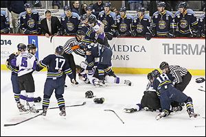 Referees attempt to break up a multiplayer fight that broke out during the second period on Saturday.