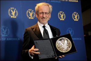 Steven Spielberg poses backstage with his feature film nomination plaque for 