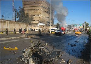 Iraqi security forces inspect the scene of a bombing in Kirkuk, 180 miles north of Baghdad, Iraq, today.