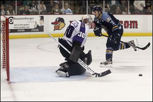 Reading goalie Drew MacIntyre deflects a penalty shot by Toledo's center Adam Hobson on Saturday. MacIntyre used to block shots at the Sports Arena.