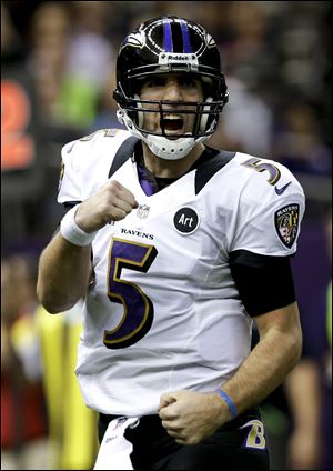 Baltimore Ravens quarterback Joe Flacco celebrates on of his three first-half touchdowns.