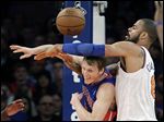  The Pistons' Kyle Singler, left, gets tangled up with the Knicks' Tyson Chandler during the first half of Monday's game at Madison Square Garden.
