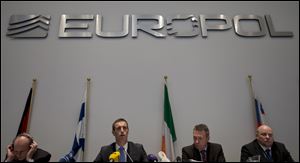 Britain's Rob Wainwright, second from left, director of the European police agency Europol, elaborates on findings of a probe into match fixing during a press conference in The Hague, Netherlands.