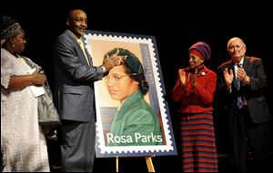 Councilwoman Joann Watson, from left, Lloyd Wesley, Jr., Detroit postmaster,  Elaine Eason Steele, co-founder of the Rosa and Raymond Parks Institute for Self Development, and Sen. Carl Levin applaud at the unveiling of the Rosa Parks' 100th birthday commemorative postage stamp at the Museum of African American History in Detroit today.