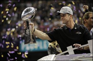 Baltimore Ravens coach John Harbaugh holds the Vince Lombardi Trophy as he celebrates his team's 34-31 win against the San Francisco 49ers in Super Bowl XLVII on Sunday in New Orleans.