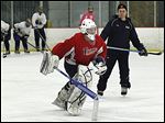  St. John's coach Mike Hayes watches goaltender Mike Barrett skate at practice. Barrett has a 1.67 goals-against average and a .929 save percentage.