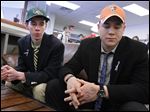  Drew Savage, left, and Jake Nachtrab, seniors at St. John's Jesuit High School in Toledo, talk about their friend and former classmate, Brian Hoeflinger, following a National Signing Day event. Savage will attend Ohio University and run cross country. Nachtrab will attend Bowling Green State University as a preferred walk-on on the football team.