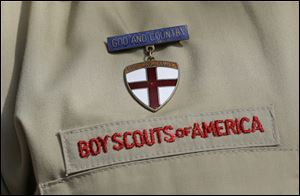 A Boy Scout uniform featuring a God and Country medal.
