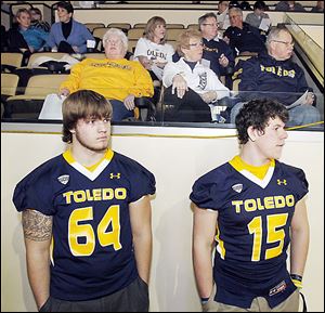 University of Toledo recruits Boston Mathews, 17, of Illinois, left, and Logan Woodside, 18, of Kentucky, listen as head coach Matt Campbell announces his team's recruiting class to fans Wednesday at Savage Arena. Woodside may have the inside track on the backup quarterback spot to Terrance Owens based on his participation in spring ball.