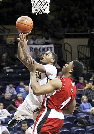 Toledo's Julius Brown shoots over Miami's Reggie Johnson. Johnson's basket with 3.3 seconds left was nearly a game-winner.