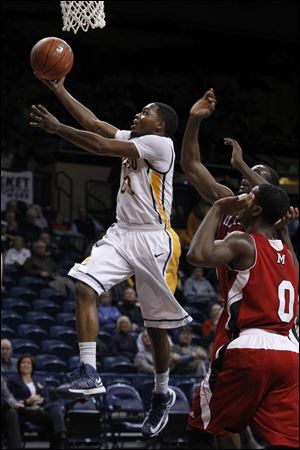 UT's Julius Brown steals the ball and drives to the basket for two against Miami.