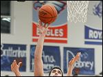  Lake's Marcus Pierce (54) takes a shot against  Otsego's John Thomas (44) and Ryan Smoyer (23) during Thursday’s contest at Lake High School. Pierce scored 14 in the win.